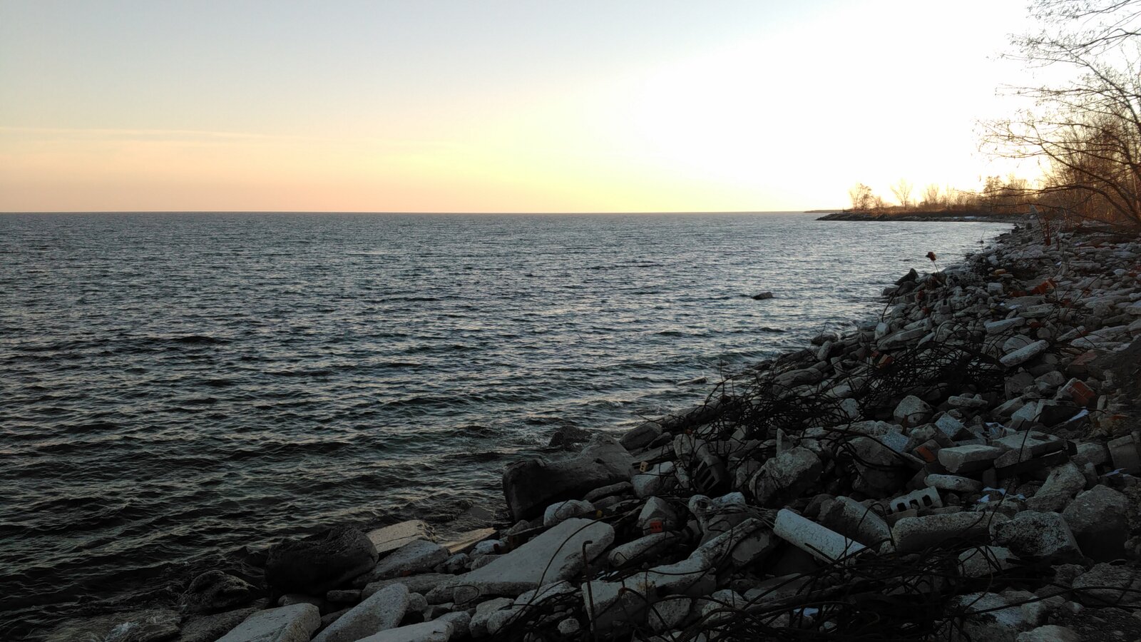 A shot of the rubble-strewn shore of the Leslie Street Spit, looking onto Lake Ontario.
